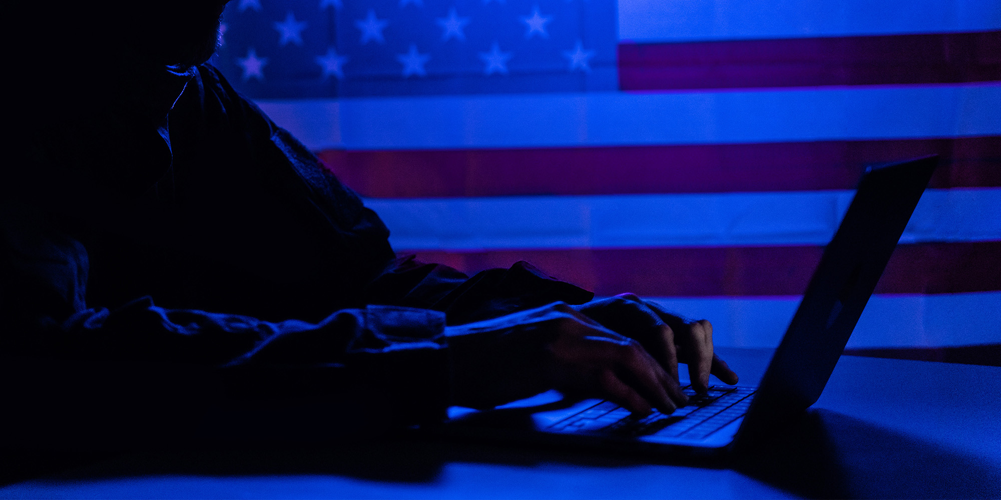hacker-with-laptop-and-usa-flag-in-background-cyb-2022-02-28-20-06-43-utc