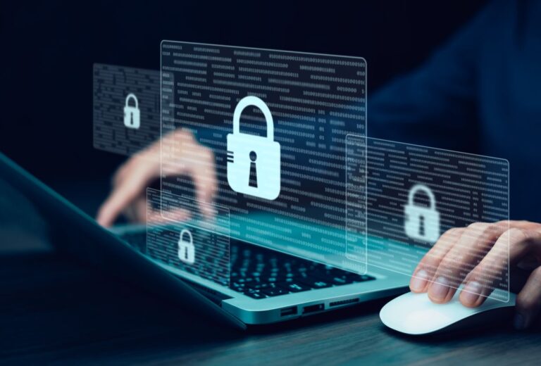 Person using a laptop with digital overlays of padlock icons and binary code representing data security. The glowing lock symbols emphasize cybersecurity protection and encrypted information on computer systems.