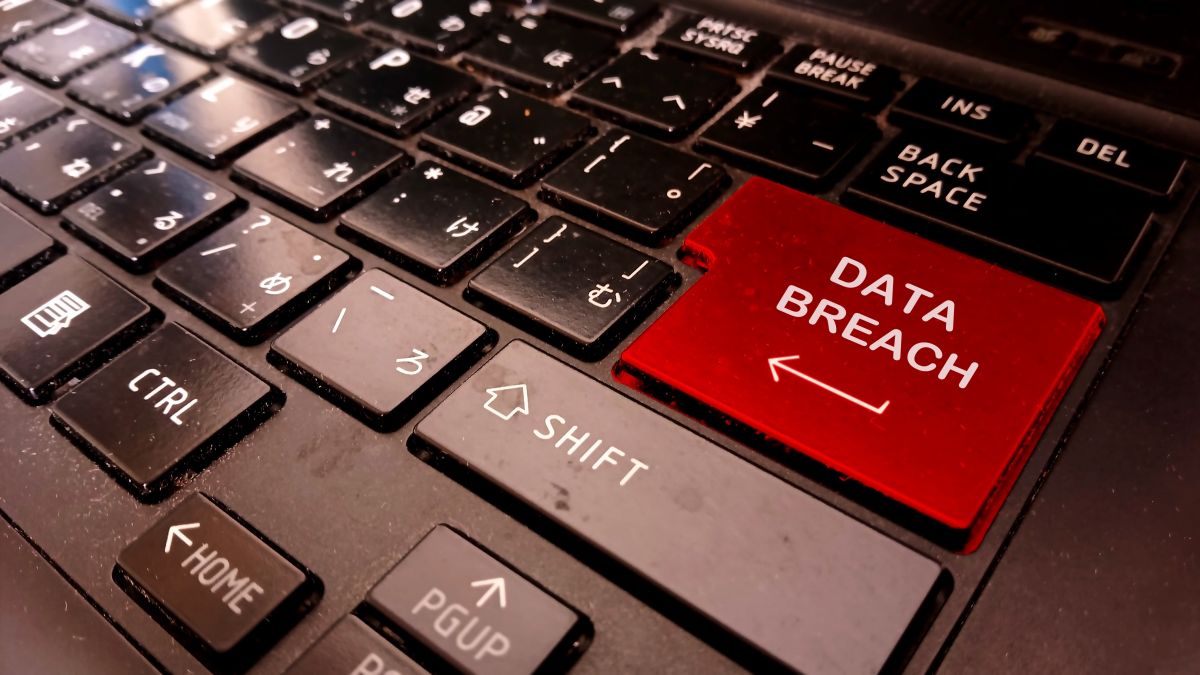 Close up of a computer keyboard with a red Enter key labeled Data Breach and a left arrow. The highlighted key emphasizes cybersecurity risks and the threat of data breaches in digital systems.