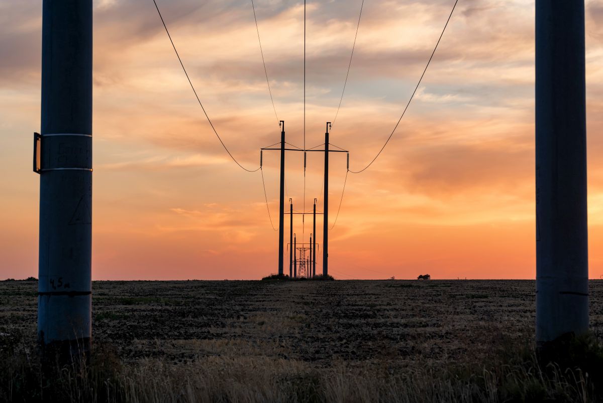 Rural landscape with power poles at sunrise