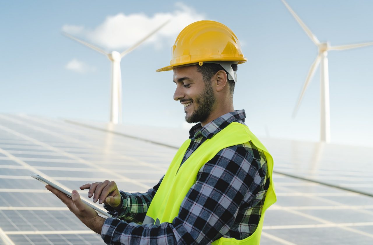 young-engineer-watching-on-tablet-the-green-plan-for-alternative-energy-with-turbine-and-solar-panel.jpg