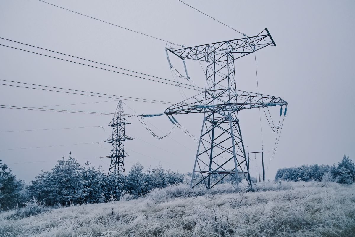 Electric voltage tower power line electricity pylon at winter snow background Electric grid resilience voltage tower power line electricity pylon at winter snow background