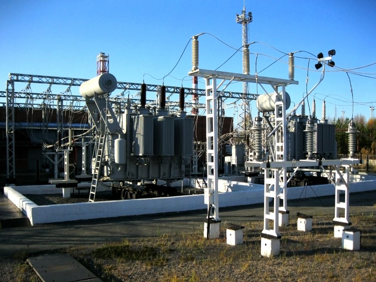 Conduct a Gap Analysis and Develop a Compliance Program - Certrec High-voltage electrical substation with transformers and power lines, showing supporting IBRs structures and equipment in a clear sky setting.
