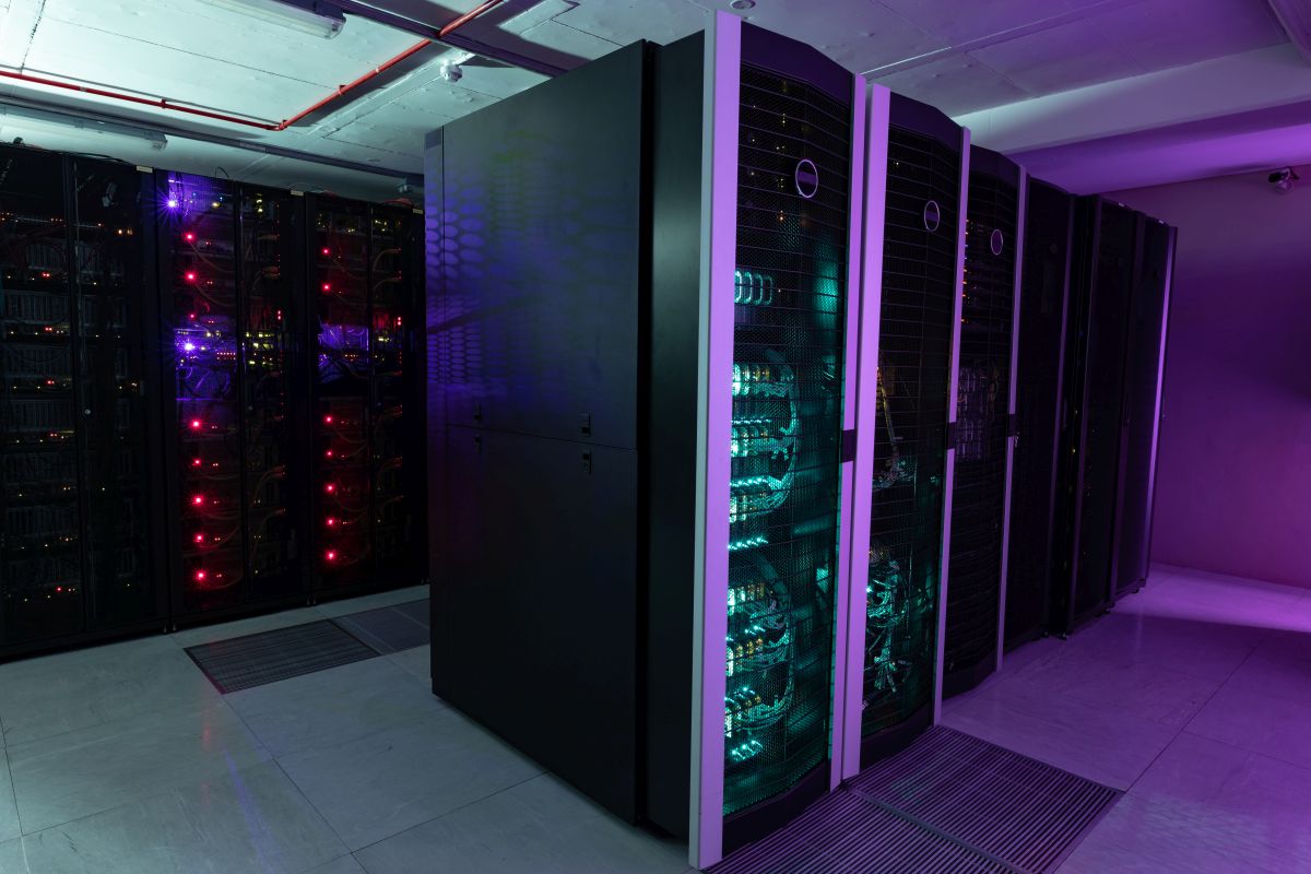 Rows of fully operational server racks in a modern data center with LED lights, showcasing advanced cloud computing technology.