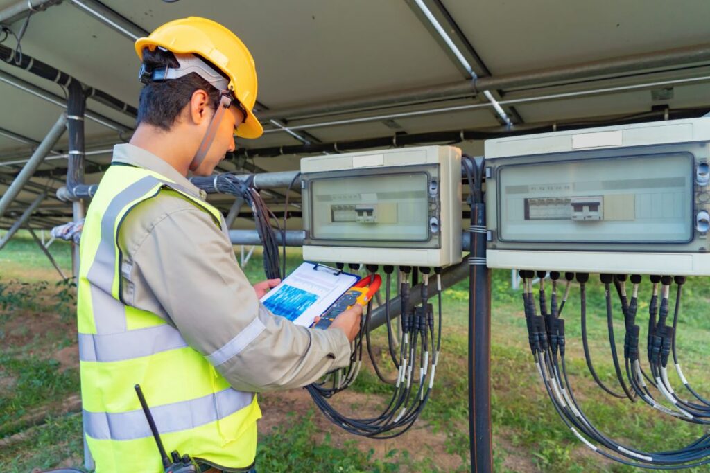 Portrait of engineer man or worker people with solar panels or solar cells on the roof in farm Power plant with green field renewable energy source in Thailand Eco technology for electric power