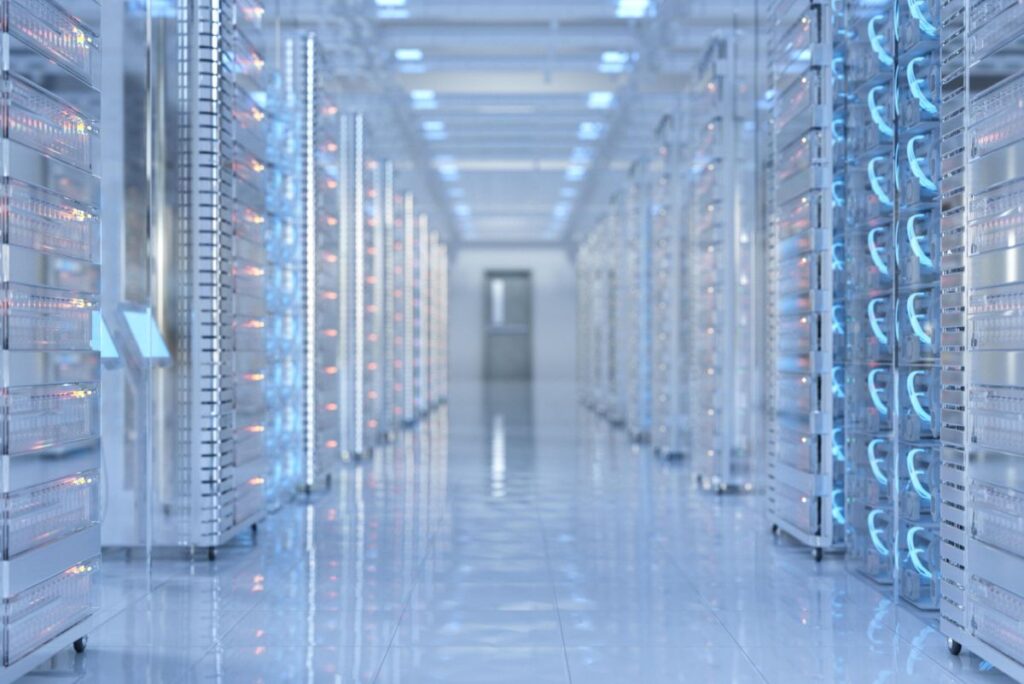 A high-tech server room with sleek rows of illuminated racks and glowing blue lights, showcasing the advanced infrastructure of the Stargate Data Center. The polished floor and bright overhead lighting emphasize a clean, modern environment.