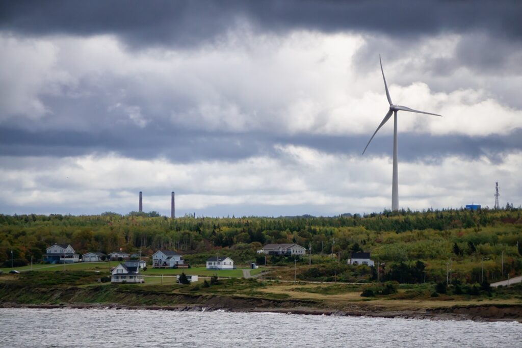 "Wind turbine near a coastal town, related to the BOEM's consideration of revoking approval for the New England Wind 1 project.