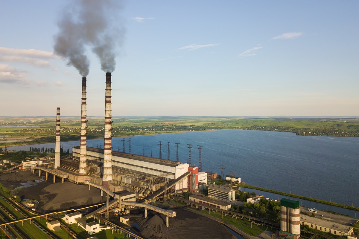 Washington state's last remaining coal plant transitioning to natural gas, with an industrial power plant and smokestacks in the foreground.