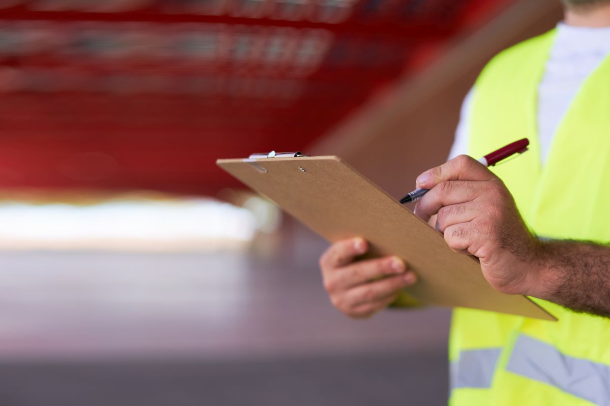 Copy space Close up of unrecognizable mans hands and taking notes at industrial plant on paper