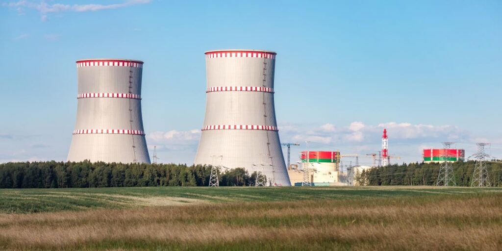 OSTROVEC BELARUS - JULY 2020 Cooling towers of nuclear power plant against the blue sky