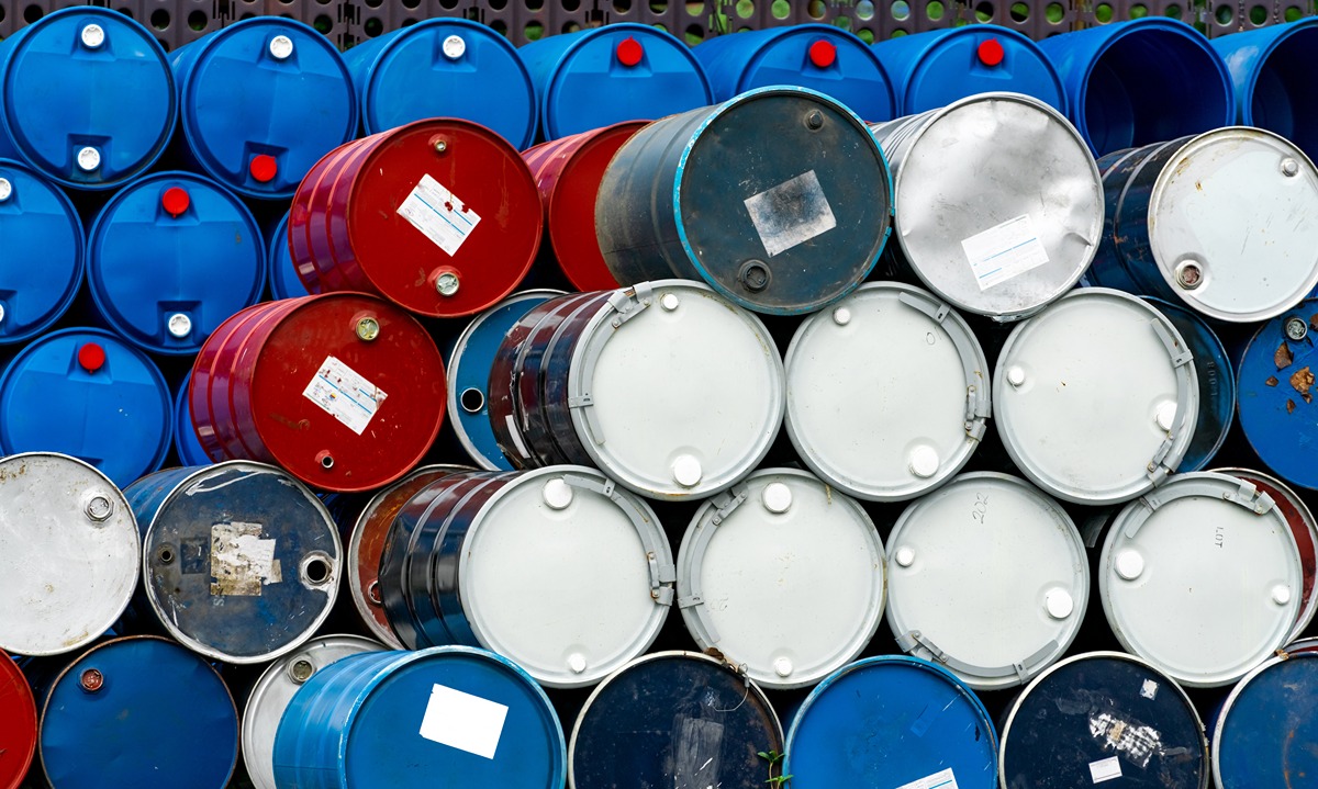 Commercial Crude Oil Inventories Increased by 20 Million Barrels-Certrec Stack of metal oil drums in blue, red, and gray colors piled in a storage yard.